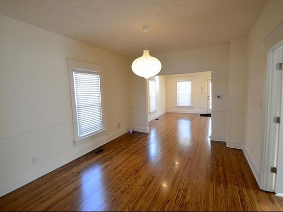 Spacious dining room and living area. Original hardwood floors.