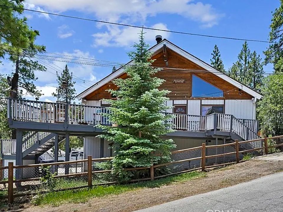 Within walking distance to the village and lake, the property features a deck with a partial lake view through the trees and includes a spa.
