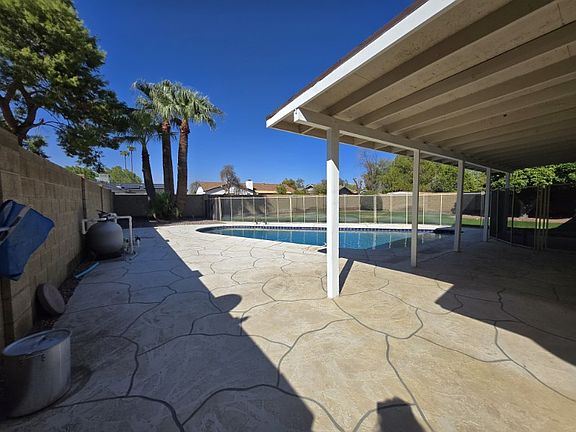 Large yard with fenced in pool