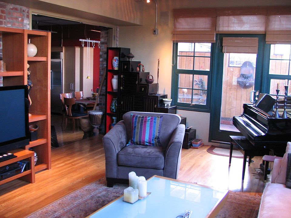 Large living room with access to two rooftop decks.
