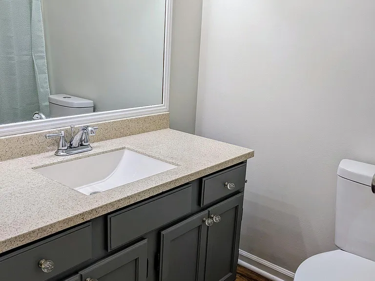 Full bath in Main bedroom. (Full shower/tub behind door (reflected in mirror.)