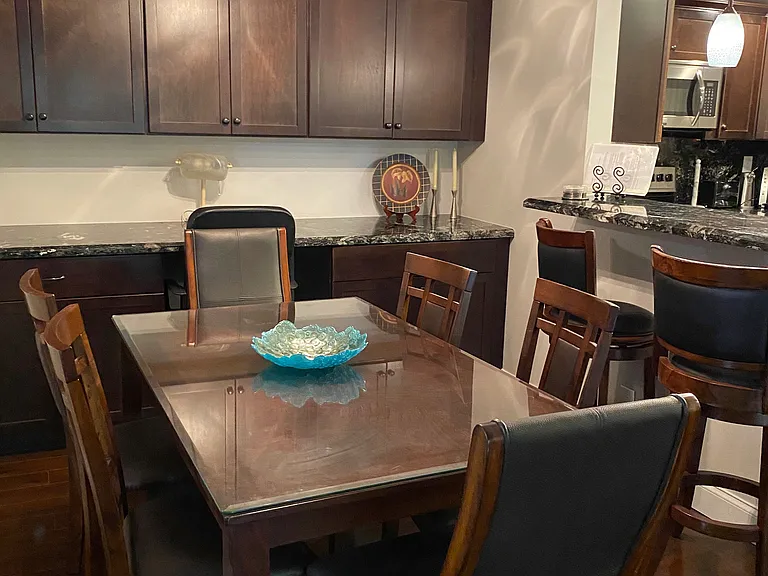 view of dining room with table and chairs and back wall has computer station with electric and storage