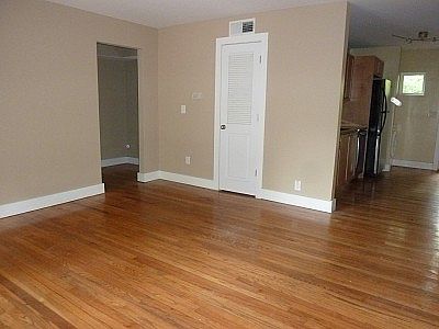 Large living room with view of kitchen and sitting area/office near master bedroom