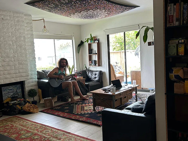 Downstairs living space with sliding doors to private patio and laundry room