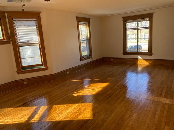 Living room window has beveled leaded glass at top that creates prism rainbows from sunset and sun reelection from school windows in mornings