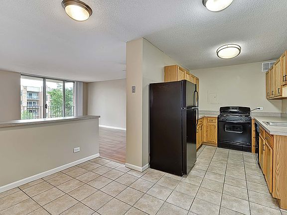 Select homes feature a modern kitchen with stainless steel appliances and a kitchen island