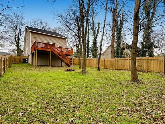Backyard with a deck and gated fence.