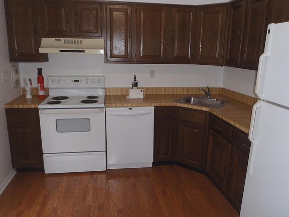 Kitchen with electric range, dishwasher, refrigerator/freezer.