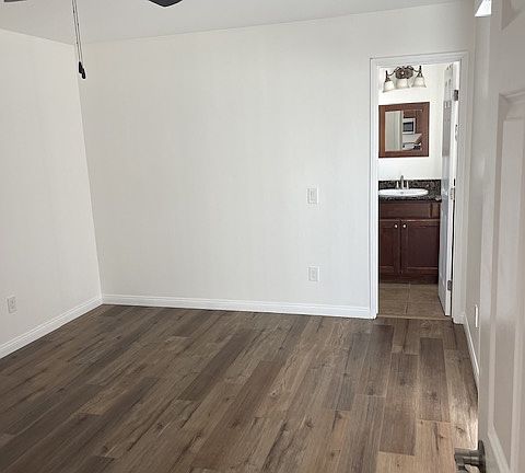 primary bedroom with entry to bathroom and walk in closet,