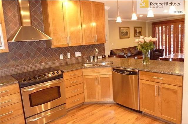 Custom cabinets, stainless steel appliances and granite counter tops are featured in this gourmet kitchen