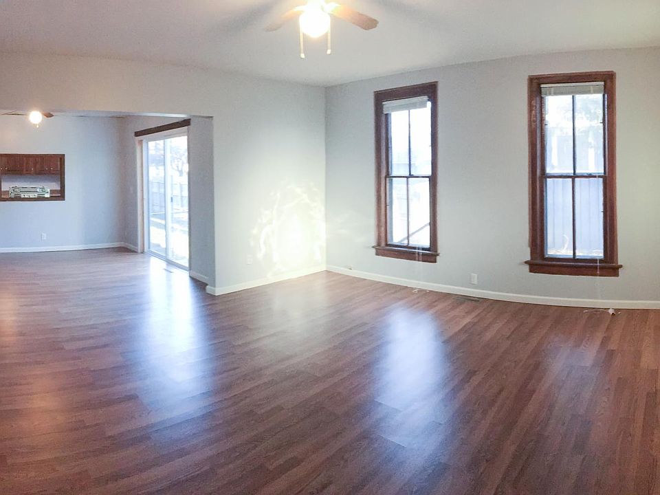 Newer floors enhanced by lots of natural light show off the large living and dining area.