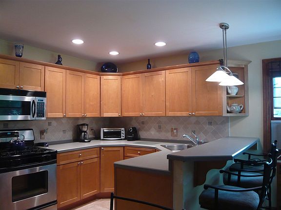 Kitchen with maple cabinets and tumbled marble backsplash
