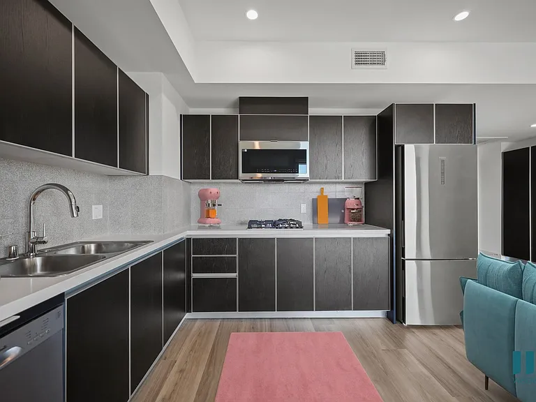 Kitchen with Refrigerator, Range Stovetop, Microwave Oven, Dishwasher, and Ample Cabinet Storage - Sherman Floor Plan