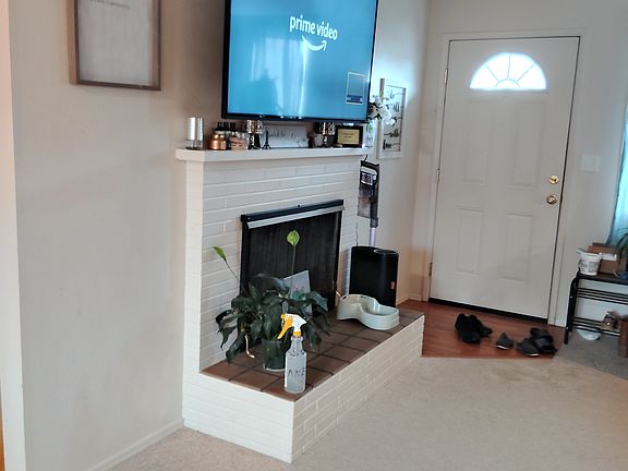 Fireplace is not functional. Television not included. This is the view toward the front door from dining area.