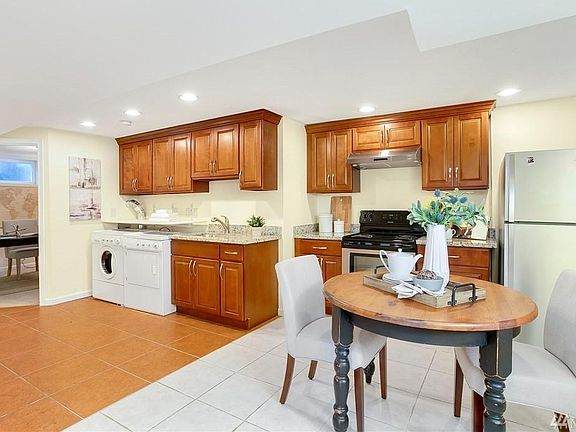 Kitchen - opposite view with peak of bonus office room. Unit is unfurnished - marketing picture only.