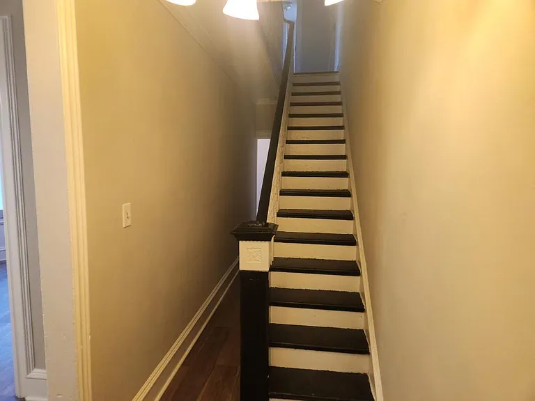 Lower floor hallway to dining room and stairs to second floor