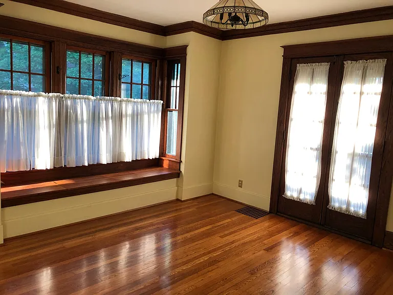 Dining room with bay window seat and French doors to back porch