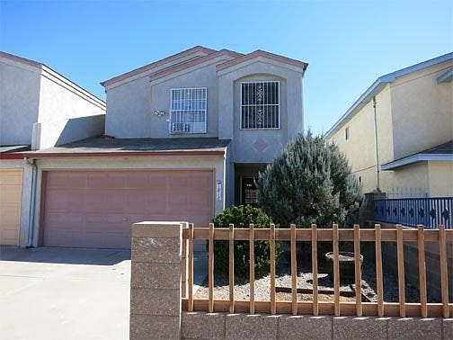 Two-car garage and xeriscaped front yard.