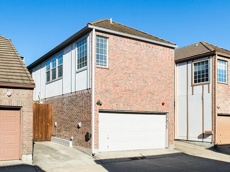Looking northwest at Garage and 3rd Parking Space to left with Patio beyond