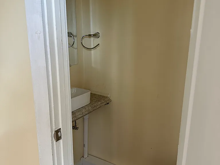 Front bedroom half bath has a sink and toilet.