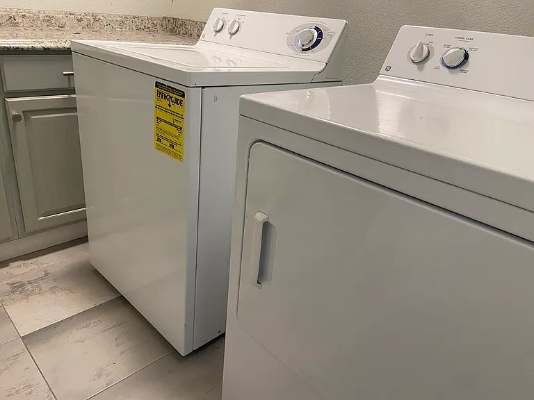Washer and dryer just outside the master bedroom
