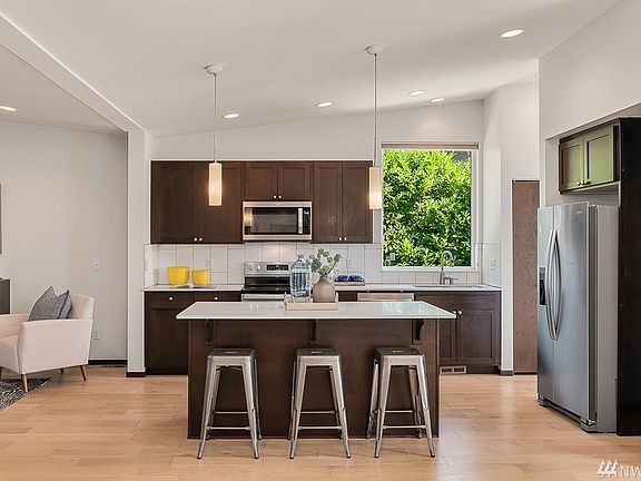 Reverse floorplan with main living areas and primary suite on upper floor. 