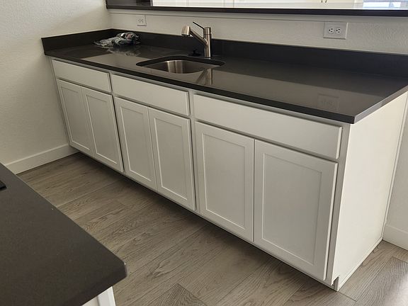 The opposite side of the kitchen where the sink and garbage disposal are located. This is also where the new dishwasher will be installed.