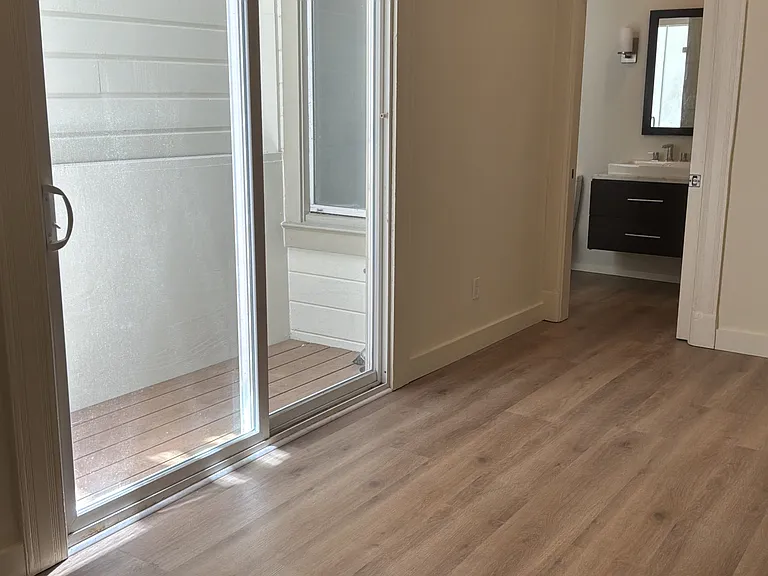 Sliding glass door off kitchen provides ample light to unit.