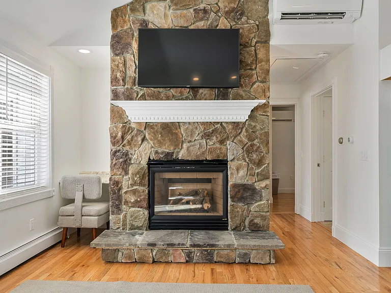 Stone Fireplace, Mantel, Mounted TV, Hardwood Floors, Mini-Split AC, Office Nook, Natural Light.