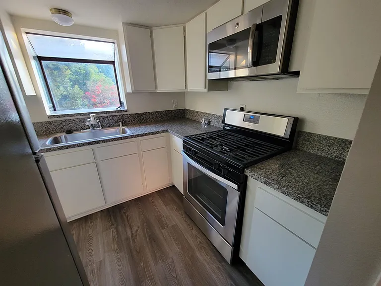Kitchen: Granite Countertop, Dishwasher, Stainless Steel Sink w Garbage Disposal, Stove, Microwave & Lots of Cabinets