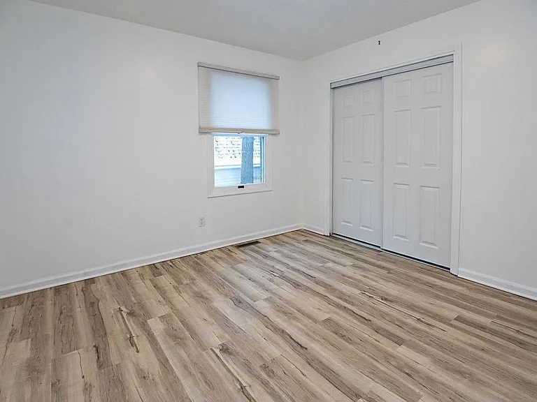 with large closetm window looks out into private backyard