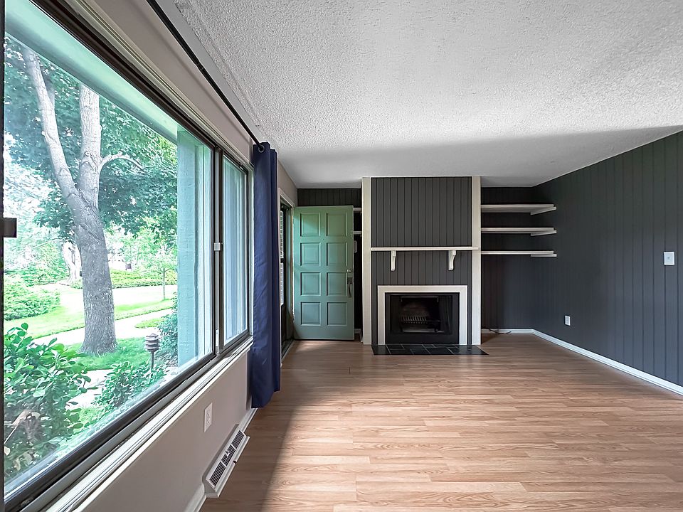 Spacious living room with large window views of the park-like community greenbelt.