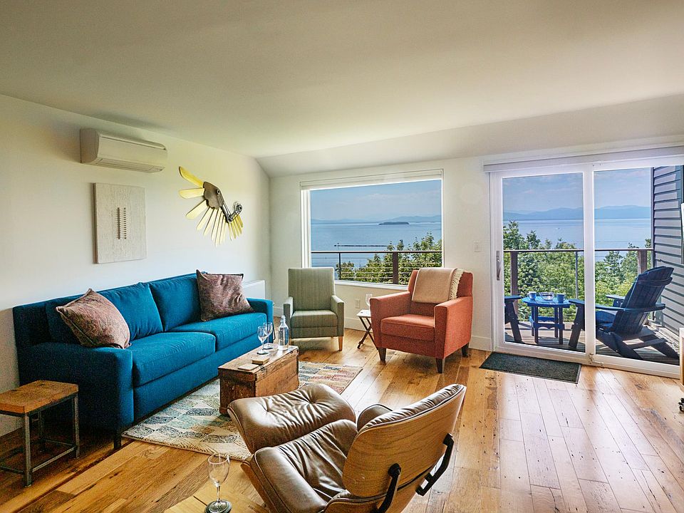 Living room, adjacent outdoor deck and its signature view.