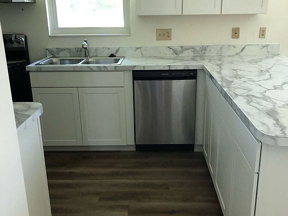 Kitchen view as you are walking into area. Island has enough over hang to fit bar stools