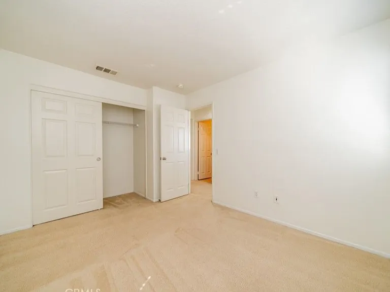 This picture shows one of the bedrooms. All three bedrooms are upstairs. Please note: Home has been upgraded with new carpet that is not shown in this picture.