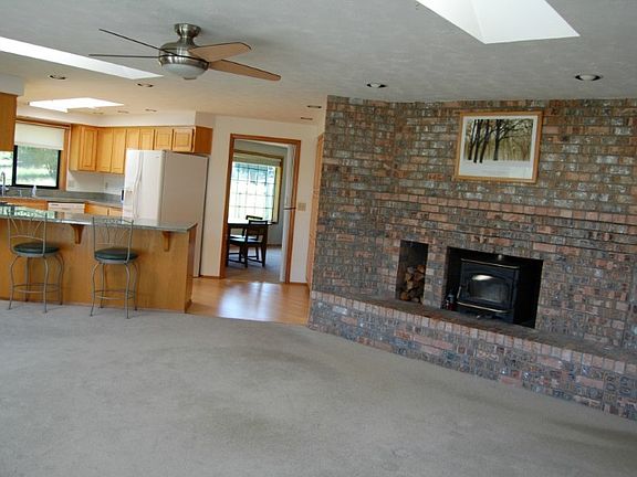 Wood sided with brick accents. Lovely oak floored entry.