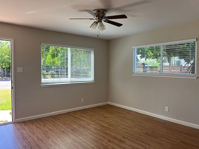 Enter in the large living room with ample natural lighting through the new dual pane windows, laminate flooring, two tone paint, wall heat/air unit.