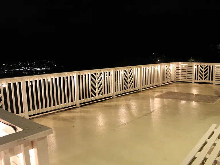 Night view of balcony with festive lighting.