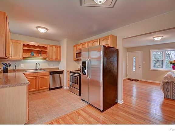 Kitchen with view of living room and front door.