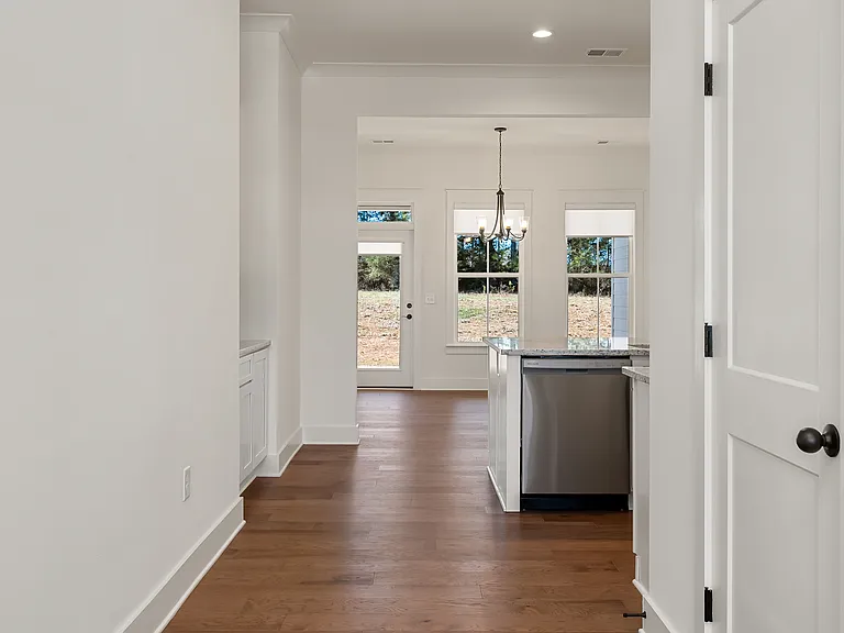 Open floor plan with hickory engineer hardwood floors in the main living area. (entrance, hall, kitchen, dinette and family room.)