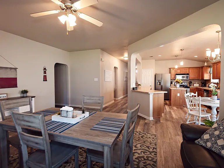 Open-concept dining area connects to the kitchen with a breakfast bar, ample cabinetry, and stainless appliances.
