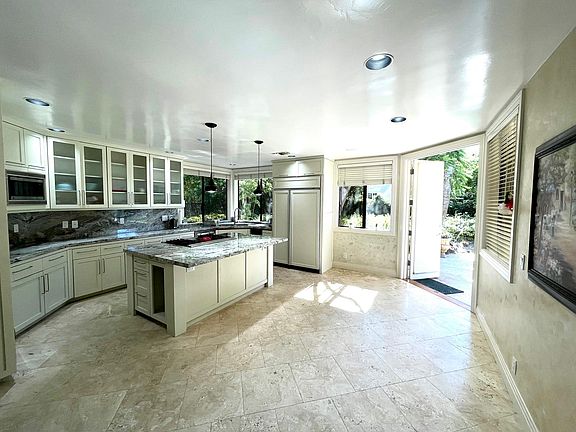 Kitchen with travertine floors and new granite countertops