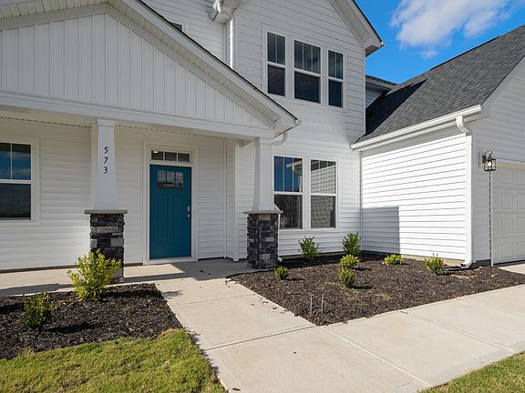 2 story single family home, all white with a 2 car garage