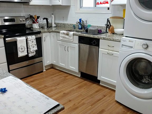 Full sized washer/dryer and kitchen cart.