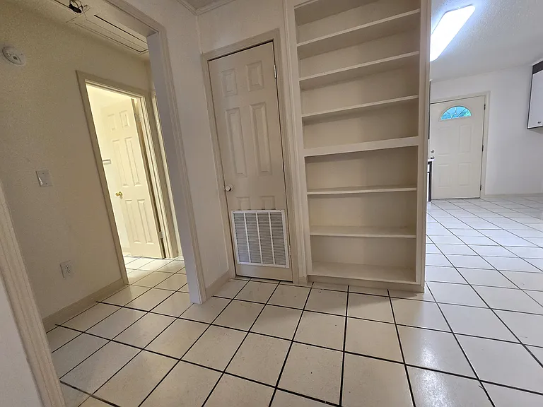Walkway between the living room, kitchen, and bedrooms/bathroom.