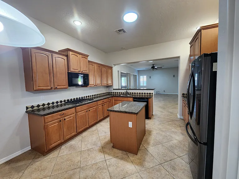 Plenty of cabinets and island with more storage