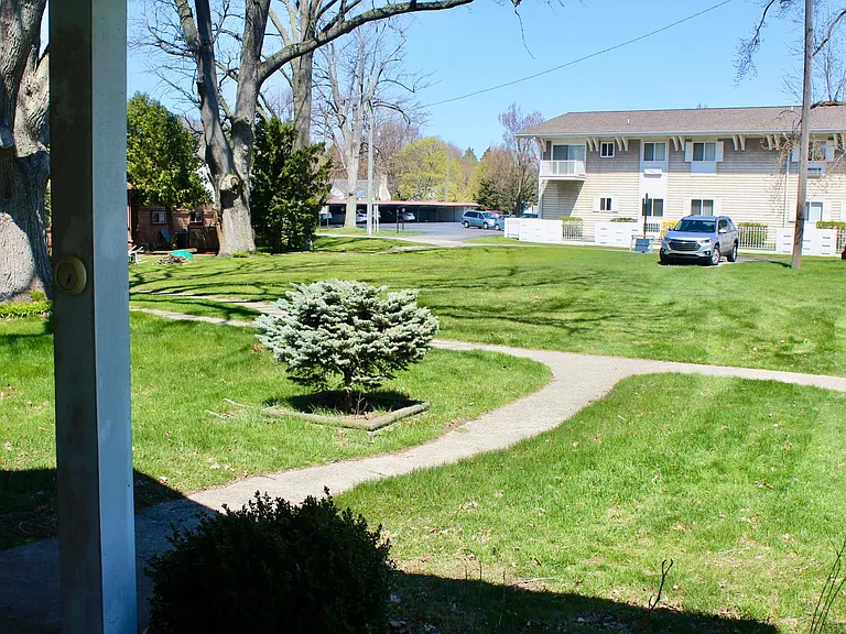 View of front yard and off road parking space