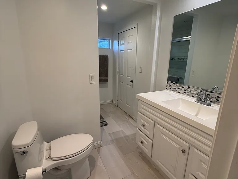 Spacious updated bathroom with oversized vanity and modern finishes