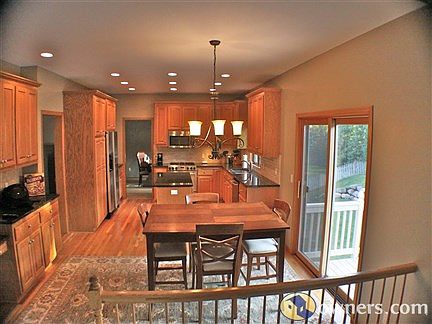 Jenn-Air SS appliances and granite in well-appointed kitchen.