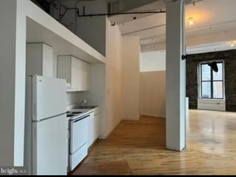 The kitchen, with an alcove that could work as a pantry and storage space